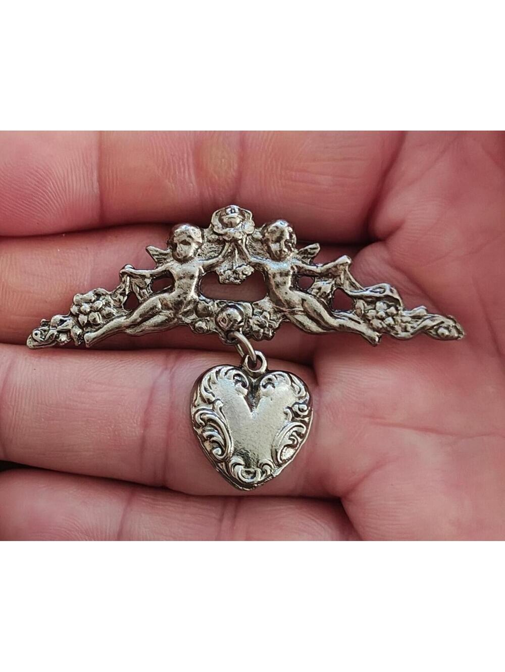 1980s Silver Tone Renaissance Style Cherub Brooch With Dangling Heart Charm